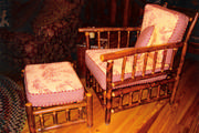 stick furniture chair with yellow toile and red checked cushions
