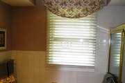 Floral bathroom window treatment with wood blind
