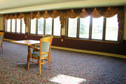 The dining room window treatment are floral swags and cascades to help the residence feel at home.
