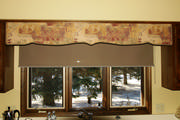 Shaped cornice over a kitchen sink take the place of the old wood apron between the upper cabinets.
