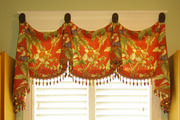 This colorful palm tree and monkey themed toile valance give a touch of whimsy to this laundry room window

