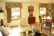 Swagged valances attached to a cornice with silk drapes is just the right amount of elegance for this dining room.
