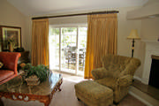 Goblet pleat gold drapes in a tone on tone stripe are mounted to a  square iron rod by Orion.
