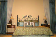 Blue faux silk dropped swags with tails valance in this master bedroom
