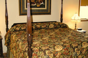 Chocolate brown drapery with quilted valance that includes braided trim and tassel. Includes a roller shade for privacy
