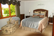 Aqua Blue and brown swagged valance mounted on a silver finish wood pole with aqua linen sheers to soften the window
