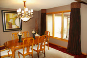 For the contemporary Dining room window, these are half barrel shaped cornices with shimmery burgundy drapes
