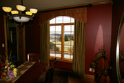 Red tapestry valance with sewn on rings and gold silk drapes all mounted on iron rods.
