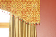 Close up of the red tapestry valance with onion trim in the dining room
