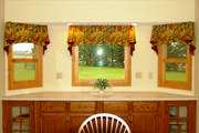 In these bay windows, the fall colored leaf fabric bring in just enough color without over powering the space.
