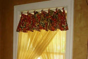 The soft golden sheers let in just enough light for the kitchen nook window.
