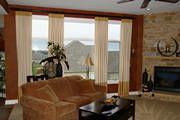 Gold and cream drapes placed over areas where the windows do not meet, helps keep the window cohesive.
