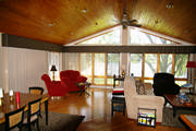 In this lake house, a large soft cornice covers the top of the verticals which are needed for that afternoon sun.
