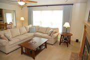 The soft blue, taupe and cream pallet give a seaside feel to this family room. The drapes are mounted of a square iron rod.
