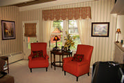 A scalloped valance in paisley and plaid with sheers coordinate nicely with the existing wallpaper.
