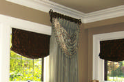 The chocolate colored soft romans are a nice contrast to the white window trim.
