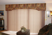 A simple arched cornice over verticals in a family room mounted next to the ceiling. 

