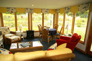 The fun sailboat fabric along with all the yellow and red add just the right amount of color to this sunroom.
