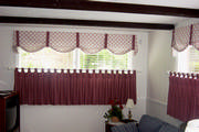 In this basement family room, the tab top drape is mounted just above the window sill to give the illusion of a longer window.
