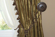 The striped silk drapes and sheers are both tied back. The cording, tassel trim and tieback all coordinate beautifully with the silk.
